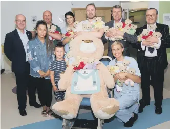  ??  ?? Freemasons from the Province of Durham at Sunderland Royal Hospital as the 12,000th TLC teddy is handed over.