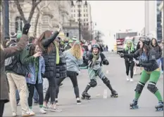  ?? Phoebe Sheehan / times union ?? Albany All Stars roller derby team members skate during the 69th Annual Albany St. Patrick’s day Parade on Saturday in Albany.