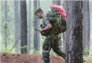  ?? (Ken Kassens/U.S. Army via AP) ?? A soldier from the U.S. Army John F. Kennedy Special Warfare Center and School checks a compass while completing a land navigation course during Special Forces Assessment and Selection near Hoffman, N.C., May 7, 2019. U.S. special operations commanders are having to do more with less and they’re learning from the war in Ukraine, That means juggling how to add more high-tech experts to their teams while still cutting their overall forces by about 5,000 troops over the next five years.