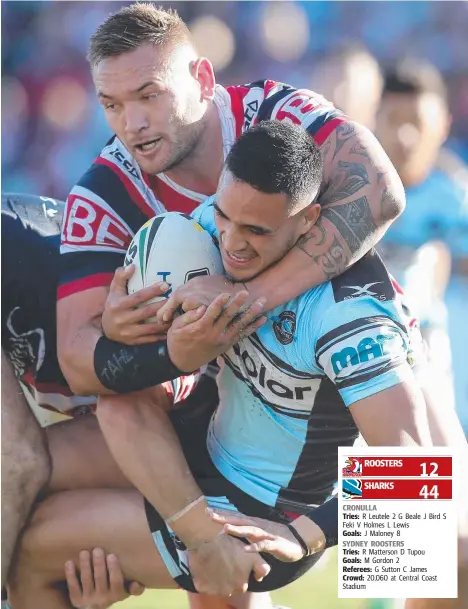  ?? Picture: GETTY IMAGES ?? Cronulla’s Valentine Holmes is tackled by Sydney Rooster Jared Waerea-Hargreaves during the Round 17 NRL clash at Central Coast Stadium in Gosford yesterday