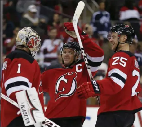  ?? ADAM HUNGER — THE ASSOCIATED PRESS ?? Devils goaltender Keith Kinkaid (1) celebrates with Mirco Mueller (25) and Andy Greene after defeating the Dallas Stars on Tuesday night.