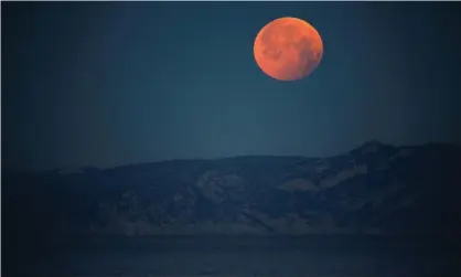  ??  ?? A ‘super blood wolf moon’ during a total lunar eclipse in Marseille, France, in January 2019. The May 2021 full supermoon will be seen on Wednesday from Australia to the US west coast. Photograph: Jean-Paul Pélissier/Reuters