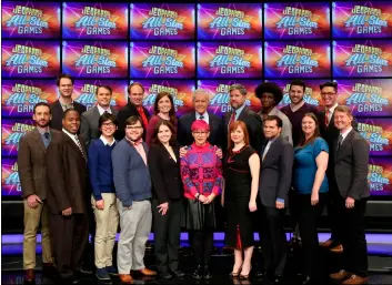  ?? JEOPARDY PRODUCTION­S, INC. VIA AP ?? This image released by Jeopardy Production­s, Inc. shows (front row from left) Brad Rutter, Colby Burnett, Alan Lin, Seth Wilson, Larissa Kelly, Monica Thieu, Pam Mueller, Matt Jackson, Jennifer Giles and Ken Jennings, back row from left, Ben Ingram, Roger Craig, David Madden, Julia Collins, host Alex Trebek, Austin Rogers, Leonard Cooper, Alex Jacob and Buzzy Cohen on the set of the game show “Jeopardy!”