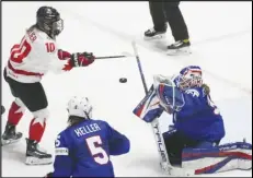  ?? Associated Press ?? United States goaltender Aerin Frankel (31) makes a save as Canada’s Sarah Fillier (10) looks for the rebound during the first period of an IIHF Women’s World Hockey Championsh­ip game on Monday in Utica, N.Y.