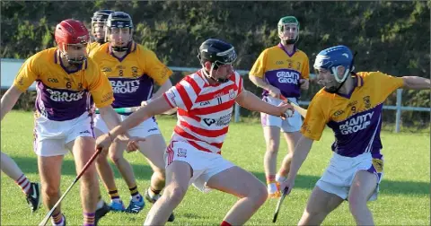 ??  ?? Pádraig Walsh of Ferns St. Aidan’s hasn’t much room to work with in his side’s draw with Faythe Harriers in Bree on Sunday.