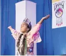  ??  ?? Victoria Eckiwardy, 9, of Edmond, performs “America the Beautiful” in sign language. She recently won the title of 2016 Little Miss Indian Oklahoma City and was chosen to perform at the conference.