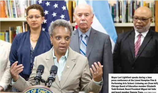  ?? SUN-TIMES FILES ?? Mayor Lori Lightfoot speaks during a June press conference at the Lionel Hampton Fine & Performing Arts School. Listening are (from left) Chicago Board of Education member Elizabeth Todd-Breland, Board President Miguel del Valle and board member Dwayne Truss.