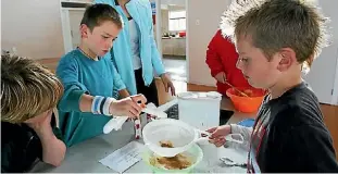  ??  ?? Cooking is one of skills children in the Rising Achievers Afterschoo­l Care Programme learn.