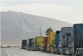  ?? ANA RAMIREZ/THE SAN DIEGO UNION-TRIBUNE 2021 ?? Semitraile­r trucks are lined up near the Otay Mesa Port of Entry in California. Changes are coming to the trucking industry.