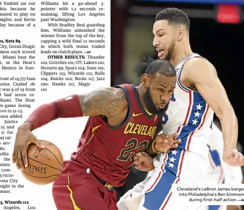  ?? —AP ?? Cleveland’s LeBron James barges into Philadelph­ia’s Ben Simmons during first-half action.