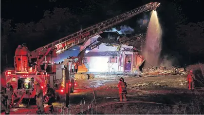  ?? ?? An excavator was brought in to help firefighte­rs put out a house fire in Hillsburn on Dec. 23.