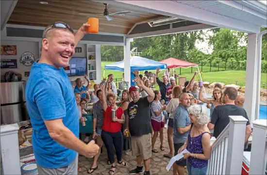  ?? Ben Braun/Post-Gazette ?? Michael Weber, of Ross, raises his cup with other guests at the 2021 Summer Porch Tour hosted by the Ya Jagoff podcast at the Bellinger home in Ohio Township.