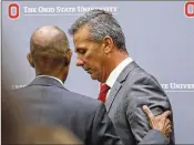  ?? PAUL VERNON / ASSOCIATED PRESS ?? Ohio State President Michael Drake talks with Urban Meyer after a news conference announcing the coach’s suspension last week.