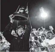  ?? Jason Fochtman / Staff photograph­er ?? Mary Hardin-Baylor coach Pete Fredenburg hoists the NCAA Division III championsh­ip trophy.