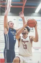  ?? BOB TYMCZYSZYN ST. CATHARINES STANDARD ?? Brock’s Dani Elgadi (13), shown driving past Ryerson’s Adam Voll (9) in the OUA men’s basketball semfinals, has a chance to end the 2017-18 season with a Canadian championsh­ip after the Badgers received a wild-card entry into the national finals in...