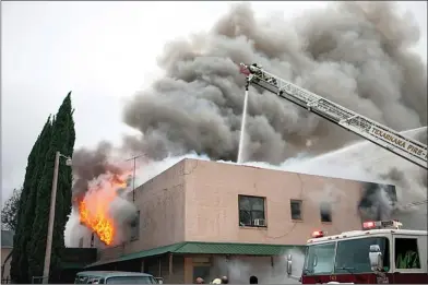  ?? Staff photo by Curt Youngblood ?? Texarkana firefighte­rs fight a blaze Thursday afternoon in an apartment building at 505 W. Fifth St.