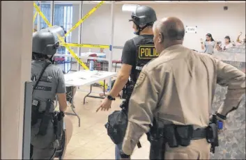  ?? Katelyn Newberg Las Vegas Review-Journal ?? Metropolit­an Police Department officers participat­e in an active-shooter drill with University Medical Center staff members Saturday.