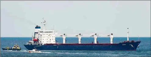  ?? ?? A boat with Russian, Ukrainian, Turkish and U.N. officials heads to the Sierra Leone-flagged cargo ship Razoni, to check if the grain shipment is in accordance with a crucial agreement signed last month by Moscow and Kyiv, at an inspection area in the Black Sea off the coast of Istanbul, Turkey, Wednesday, Aug. 3. (AP)