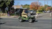  ?? ?? Cameron Litvinchuk rides his military golf truck on Thursday in the Oroville Veterans Day parade in Oroville.