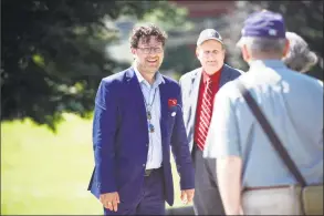  ?? Michael Cummo / Hearst Connecticu­t Media file photo ?? Then-Democratic candidate for state Rep. David Michel smiles as he greets a voter outside the First Presbyteri­an Church on primary day in Stamford last August.