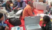  ?? — PTI ?? Polling officers collect EVMs before leaving for booth in Nagar Palika Election in Lucknow on Saturday.