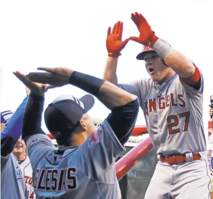  ?? FRANK VICTORES, USA TODAY SPORTS ?? Mike Trout, right, gets high-fives from American League teammate Jose Iglesias after hitting a home run to lead off the All-Star Game on Tuesday. Trout was MVP.