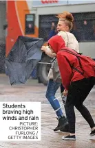  ?? PICTURE: CHRISTOPHE­R FURLONG / GETTY IMAGES ?? Students braving high winds and rain