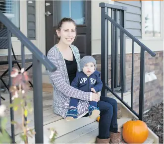  ?? ADRIAN SHELLARD ?? Kayla Pugh and her son Carsen Thompson sit outside their rental townhome in Birchwood’s West Townes in the Cochrane community of Heartland.