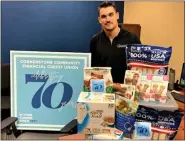  ?? PHOTO COURTESY OF CORNERSTON­E COMMUNITY FINANCIAL ?? Cornerston­e Community Financial team member Mateusz Tylecki is pictured with the donations of cat and dog food, chew toys, treats, bones and warm blankets for the animals awaiting adoption at Rochester Hills Humane Society.