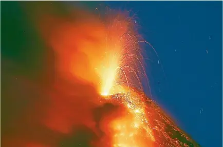  ?? PHOTO: AP ?? Mayon volcano erupts for a second straight day as lava cascades down its slopes, as seen from Legazpi city, about 340km southeast of Manila.