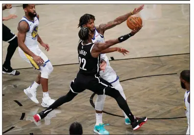  ?? (AP/Kathy Willens) ?? Carvis LeVert (22) of the Brooklyn Nets drives to the basket while being defended by Golden State Warriors forward Marquese Chriss during Tuesday night’s game.