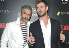  ?? JAMIE MCCARTHY/GETTY IMAGES ?? Director Taika Waititi, left, and Chris Hemsworth attend a screening of Thor: Ragnarok in New York. Waititi encouraged improv and humour on the movie set.