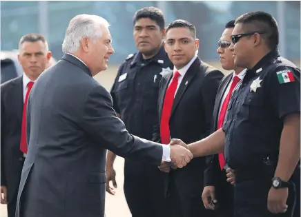  ?? Picture / AP ?? Rex Tillerson is greeted by police officers and security personnel at Mexico City’s internatio­nal airport.