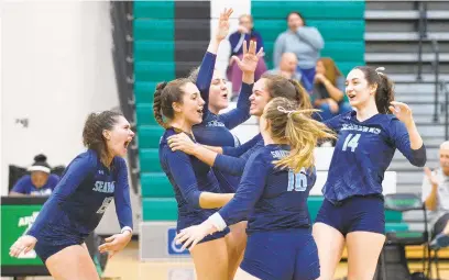  ?? PAUL W. GILLESPIE/BALTIMORE SUN MEDIA GROUP ?? South River celebrates a point in the first game of its 25-12, 25-12, 25-23 victory over Arundel. The unbeaten Seahawks earned a measure of revenge against the Wildcats, who handed them three straight losses last season on the way to a region championsh­ip.