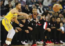  ?? Bay Area News Group/tns ?? Golden State Warriors’ Stephen Curry passes the ball against Portland Trail Blazers’ Damian Lillard during the first quarter of a NBA game at Oracle Arena in December 2017.