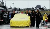  ?? PAUL ABELL / AP ?? Driver Joey Logano’s car is covered and pushed during a rain shower before Sunday’s NASCAR race at Atlanta Motor Speedway.