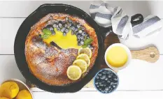  ??  ?? Lemon Blueberry Dutch Baby Pancake, from Oh Sweet Day! The Celebratio­n Cookbook, by Fanny Lam.