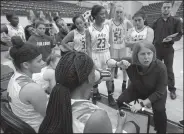  ?? NWA Democrat-Gazette/ANDY SHUPE ?? Springdale girls basketball coach Heather Hunsucker speaks to her team against Rogers’ on Saturday. Visit nwadg.com/photos to see more photograph­s from the games.