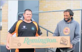  ??  ?? DEREK Morse receives his rifle worth $1000 as a spot prize from sponsor Richard France of Dannevirke Hunting and Fishing.