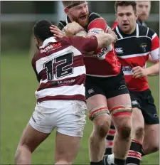  ??  ?? Keiaho Bloomfield of Tullow tries to halt the progress of Liam Gaffney.