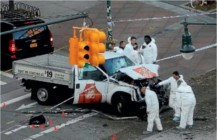  ?? PHOTO: REUTERS ?? A police forensic team inspects the rental truck used in the ramming attack that killed eight people on the West Side Highway bike path in Manhattan, the greatest loss of life from a suspected terrorist attack in New York since the 9/11 attacks.