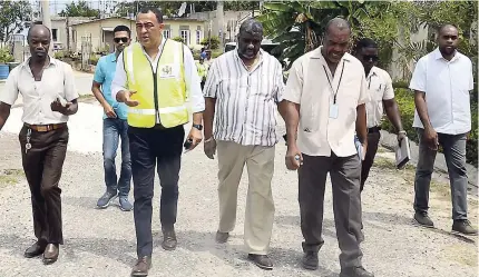  ??  ?? Minister of Health Dr Christophe­r Tufton (second left) leads a team on a vector control exercise in the community of Hague, Trelawny, last Friday. Touring with him are (from left) parish public health specialist for vector control in Trelawny Devon Ledgister, Regional Director of the Western Regional Health Authority Errol Greene, and Chief Public Health Inspector for Trelawny Delroy Mowatt.