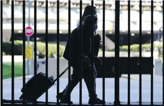  ?? THE ASSOCIATED PRESS ?? Masked travellers walk to a parking lot at O’Hare Internatio­nal Airport in Chicago in 2021. Demand for travel has returned to pre-pandemic levels just in time for travel’s hottest season — summer.