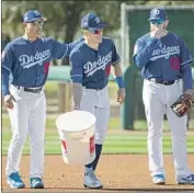  ?? Gina Ferazzi Los Angeles Times ?? MAX MUNCY, right, a nonroster invitee last year, will begin the season primarily as a first baseman.