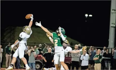  ?? Tim Godbee ?? Calhoun’s Gage Leonard makes a one-handed intercepti­on in a 32-27 win over Blessed Trinity.