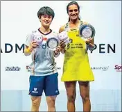  ?? PTI ?? Badminton players India's PV Sindhu and China's Wang Zhi Yi atop the podium pose for photograph­s after the final match of the Singapore Open 2022