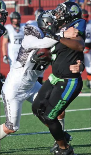  ?? RANDY MEYERS — THE MORNING JOURNAL ?? The Nightmares’ C.J. Powell is hit hard by Marlon Oden of the Ohio Raiders after a short gain during the first quarter on July 15.