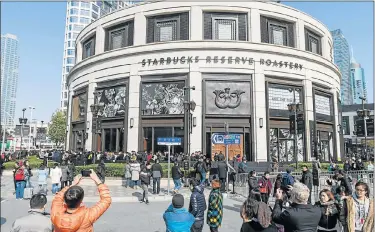  ?? Picture: AFP ?? BIG EVENT: People throng to see the new Starbucks Reserve Roastery outlet in Shanghai yesterday