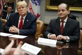  ?? EVAN VUCCI ?? FILE - In this Sept. 17, 2018, file photo, President Donald Trump, left, and Labor Secretary Alexander Acosta listen during a meeting of the President’s National Council of the American Worker in the Roosevelt Room of the White House in Washington. The arrest of billionair­e financier Jeffrey Epstein on child sex traffickin­g charges is raising new questions about the future of Acosta as well as Epstein’s relationsh­ips with several major political figures, including President Donald Trump and former President Bill Clinton.