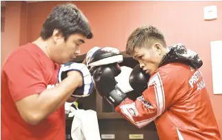  ??  ?? FILIPINO IBF super flyweight champion Jerwin Ancajas (R) busy in training with coach Joven Jimenez in Fresno, California for his upcoming title defense against compatriot Jonas Sultan.